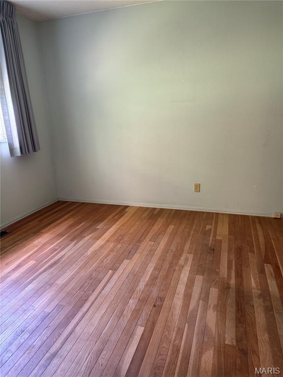 11646 Esperanza Dr, Florissant, MO 63033 - spare room featuring hardwood / wood-style floors and baseboards