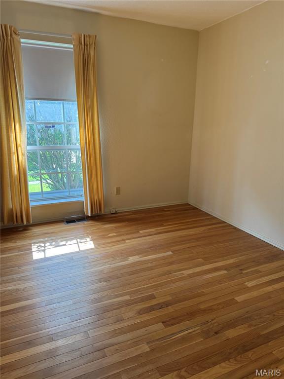 11646 Esperanza Dr, Florissant, MO 63033 - spare room featuring wood-type flooring and baseboards
