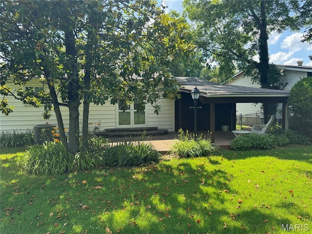 11646 Esperanza Dr, Florissant, MO 63033 - back of house featuring a yard and a patio area