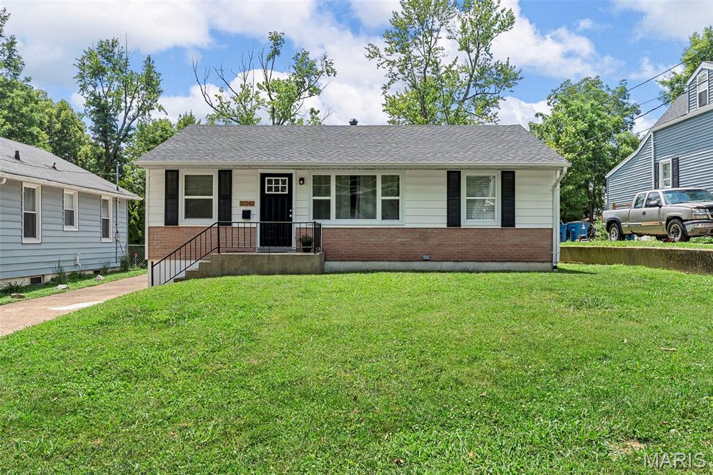 10240 Driver Ave, Saint Louis, MO 63114 - view of front facade featuring brick siding and a front lawn