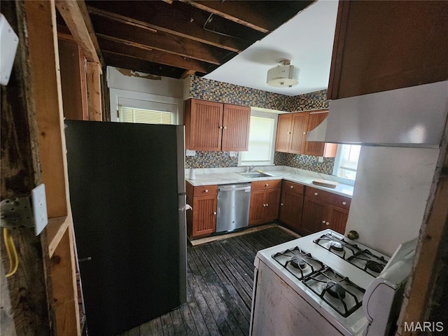 3309 Calvert Ave, Breckenridge Hills, MO 63114 - kitchen featuring freestanding refrigerator, stainless steel dishwasher, gas range gas stove, light countertops, and dark wood-style floors