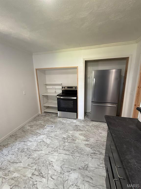 804 W Bain St, Dexter, MO 63841 - kitchen featuring stainless steel appliances, crown molding, a textured ceiling, and stone countertops