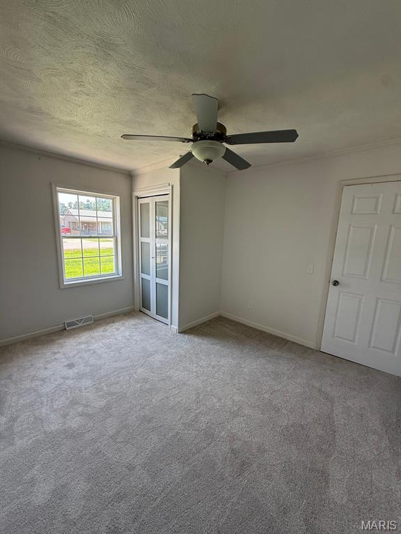 804 W Bain St, Dexter, MO 63841 - unfurnished room featuring a ceiling fan and carpet flooring