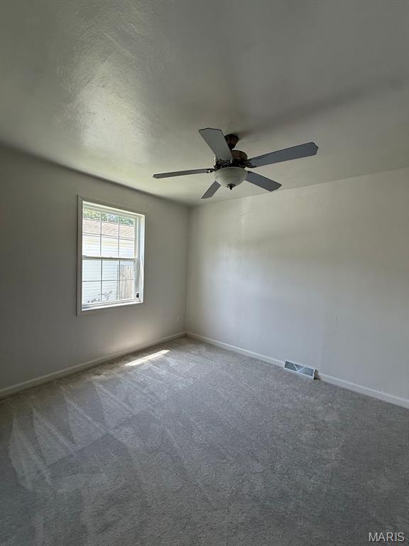 804 W Bain St, Dexter, MO 63841 - carpeted empty room with a ceiling fan and baseboards