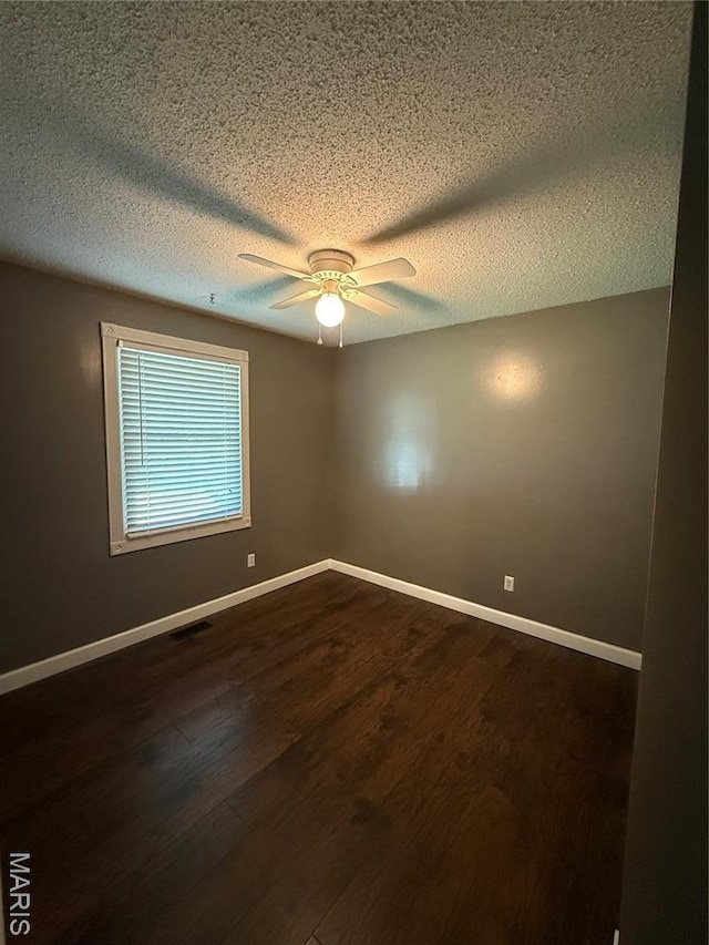 812 Sommerset Dr, Troy, MO 63379 - empty room featuring a textured ceiling, dark wood finished floors, and a ceiling fan