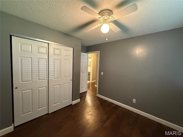 812 Sommerset Dr, Troy, MO 63379 - unfurnished bedroom featuring dark wood-style flooring, a closet, a textured ceiling, and a ceiling fan