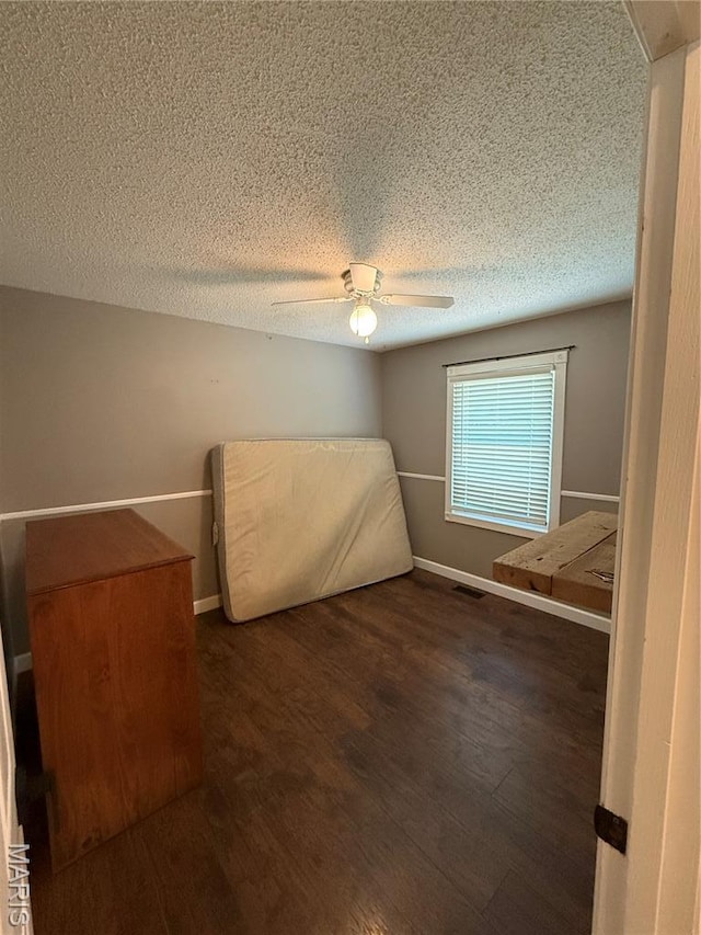 812 Sommerset Dr, Troy, MO 63379 - unfurnished bedroom with wood finished floors, a textured ceiling, and a ceiling fan