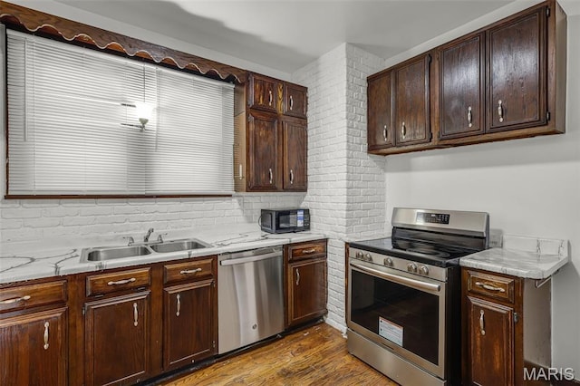 125 N 41st St, Belleville, IL 62226 - kitchen featuring appliances with stainless steel finishes, light countertops, dark wood-style floors, dark brown cabinets, and tasteful backsplash