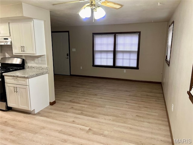 76 Cheshire Dr, Belleville, IL 62223 - kitchen featuring stainless steel range with gas stovetop, ventilation hood, light wood-style flooring, white cabinetry, and light countertops