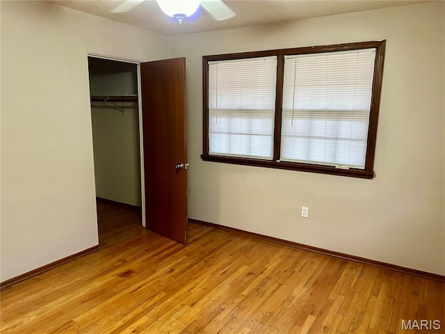 76 Cheshire Dr, Belleville, IL 62223 - unfurnished bedroom with a closet, light wood-type flooring, and a ceiling fan