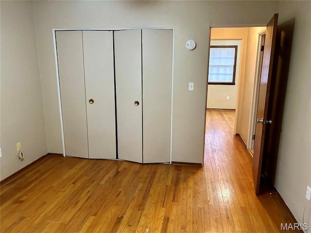 76 Cheshire Dr, Belleville, IL 62223 - unfurnished bedroom with light wood finished floors and a closet