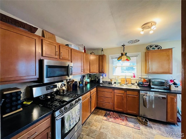 15315 Humbert Rd, Brighton, IL 62012 - kitchen with appliances with stainless steel finishes, dark countertops, and brown cabinetry