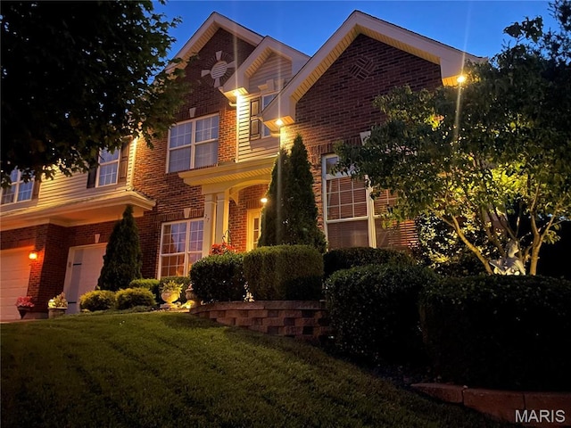 27 Carlton Lake Ct, Wentzville, MO 63385 - traditional home with brick siding, a front yard, and a garage