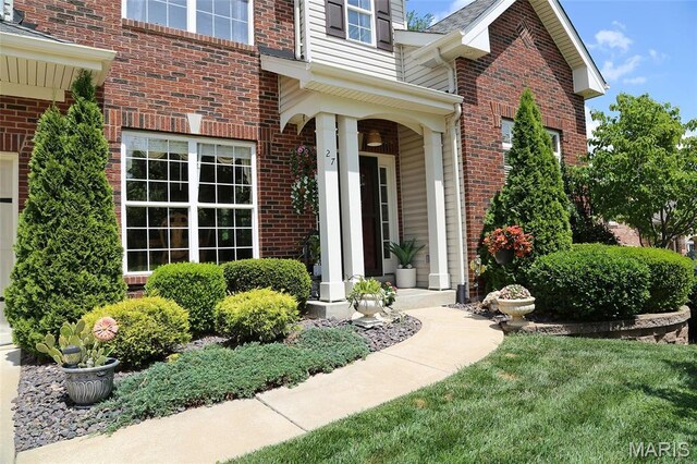 27 Carlton Lake Ct, Wentzville, MO 63385 - doorway to property featuring brick siding and covered porch