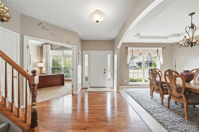 27 Carlton Lake Ct, Wentzville, MO 63385 - foyer entrance with light wood finished floors, stairway, and a chandelier