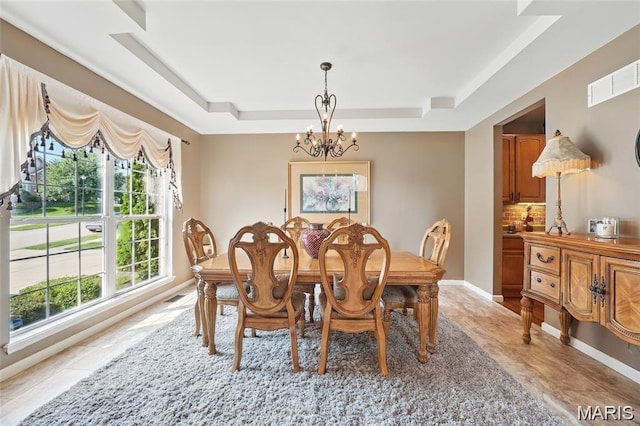 27 Carlton Lake Ct, Wentzville, MO 63385 - dining space featuring a raised ceiling and a chandelier