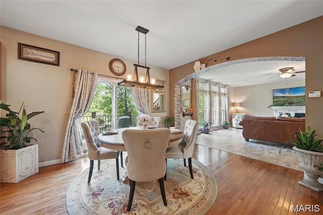 27 Carlton Lake Ct, Wentzville, MO 63385 - dining area featuring light wood finished floors, a chandelier, and a ceiling fan