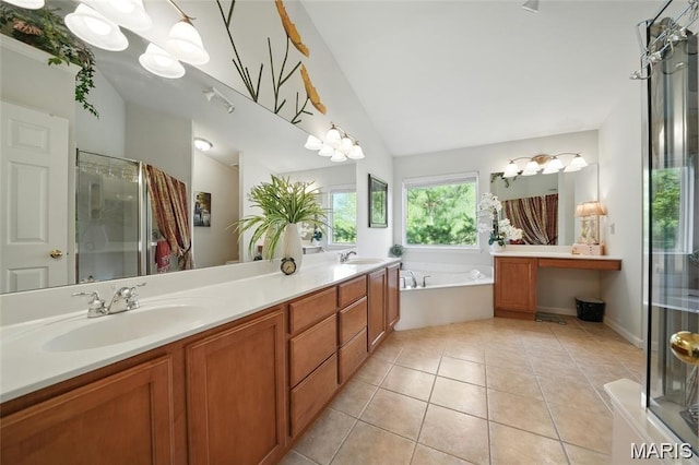 27 Carlton Lake Ct, Wentzville, MO 63385 - bathroom with double vanity, a shower stall, lofted ceiling, a garden tub, and tile patterned flooring