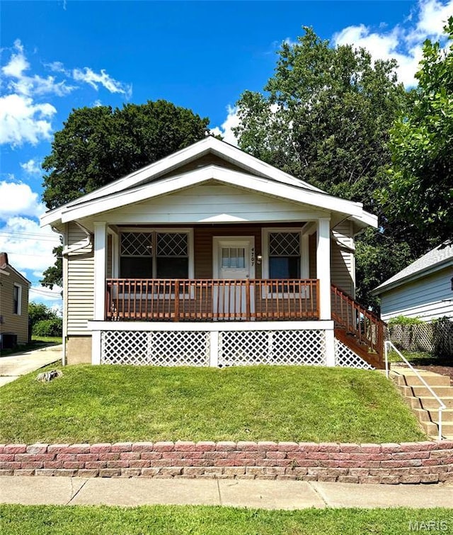 4707 Primm St, Saint Louis, MO 63116 - view of front of house featuring covered porch and a front yard