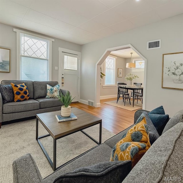 4707 Primm St, Saint Louis, MO 63116 - living room with light wood-style floors, arched walkways, and a drop ceiling