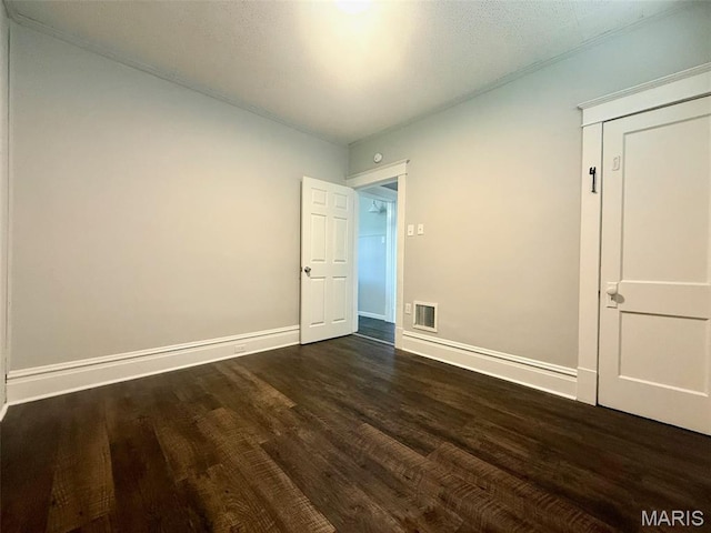 4707 Primm St, Saint Louis, MO 63116 - unfurnished bedroom featuring wood finished floors and baseboards