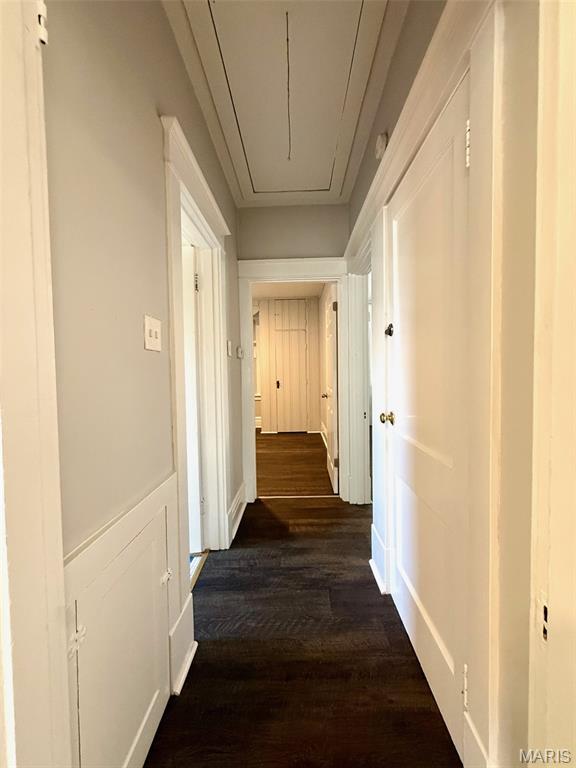 4707 Primm St, Saint Louis, MO 63116 - hallway featuring attic access and dark wood finished floors