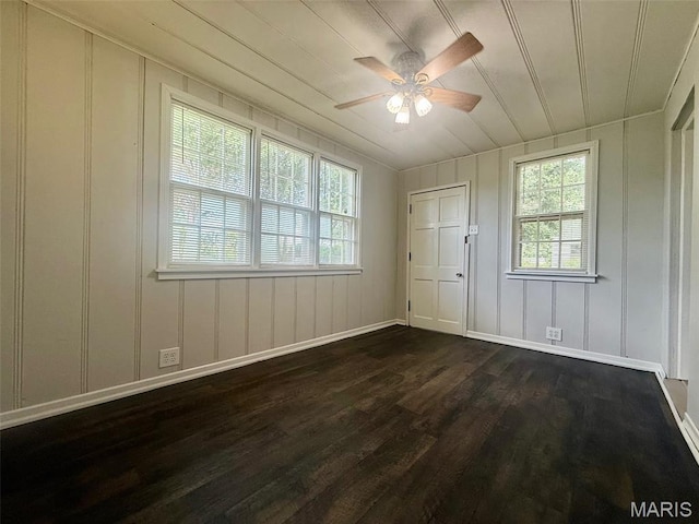 4707 Primm St, Saint Louis, MO 63116 - unfurnished bedroom with dark wood-type flooring, a decorative wall, and a ceiling fan
