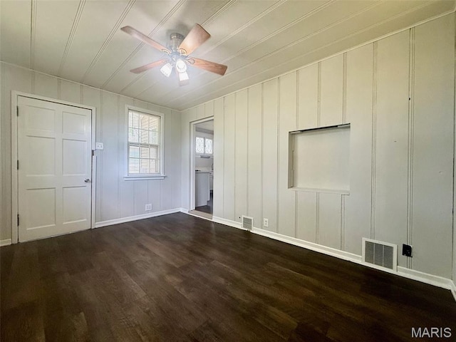 4707 Primm St, Saint Louis, MO 63116 - unfurnished living room with ceiling fan, dark wood-style floors, and a decorative wall
