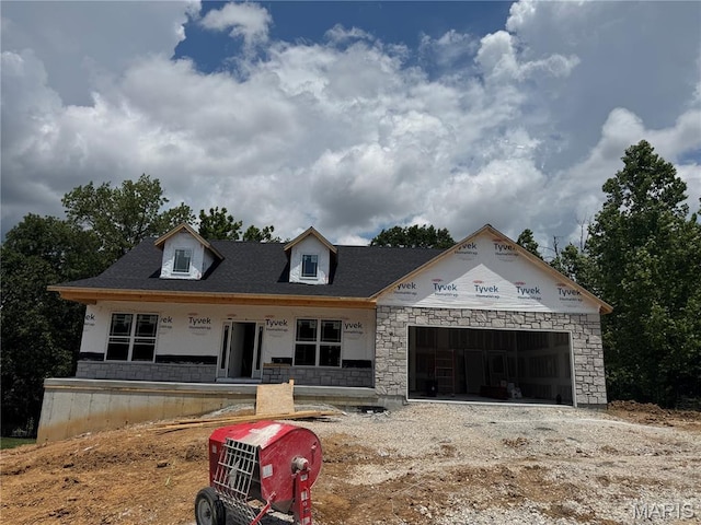 268 Auburn Ridge Dr, Troy, MO 63379 - property in mid-construction with an attached garage, a porch, stone siding, and driveway