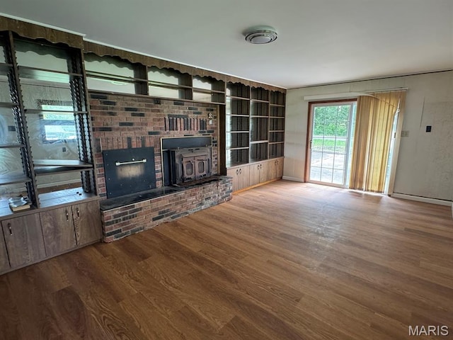 48 E N Ave, Ellsinore, MO 63937 - unfurnished living room featuring wood finished floors and a fireplace