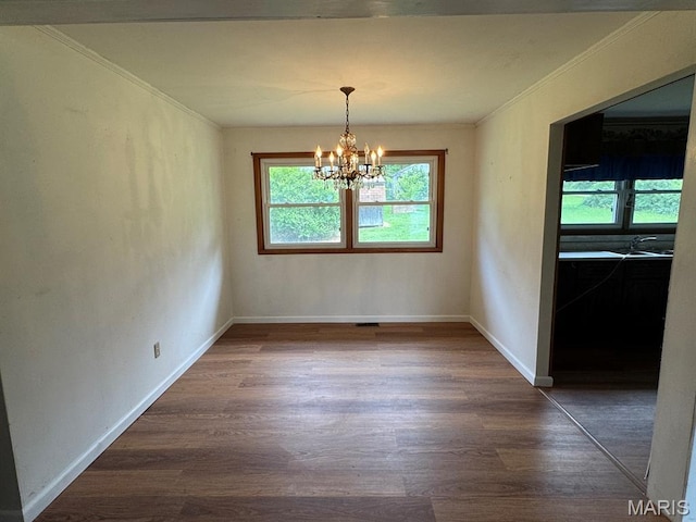 48 E N Ave, Ellsinore, MO 63937 - unfurnished dining area with dark wood finished floors, crown molding, and a chandelier