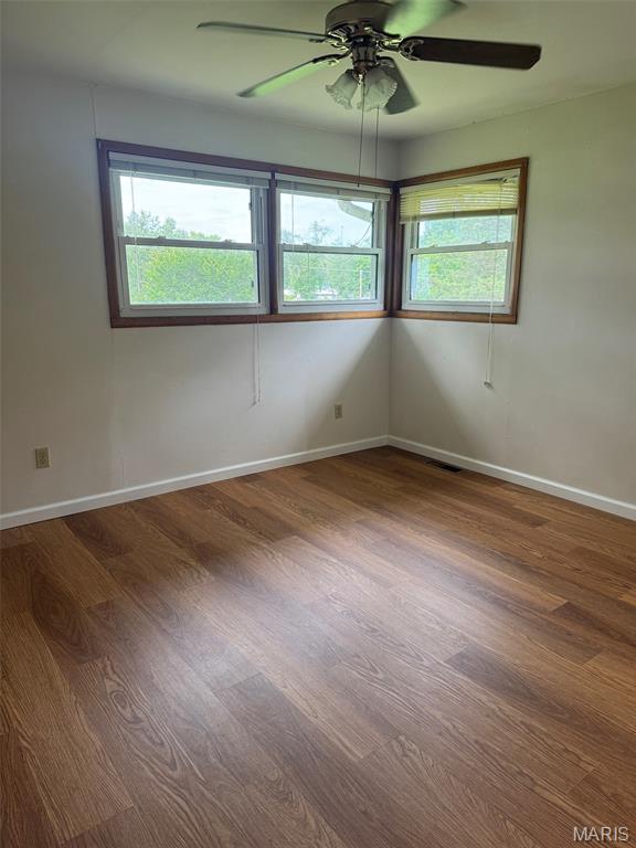 48 E N Ave, Ellsinore, MO 63937 - empty room with wood finished floors and ceiling fan