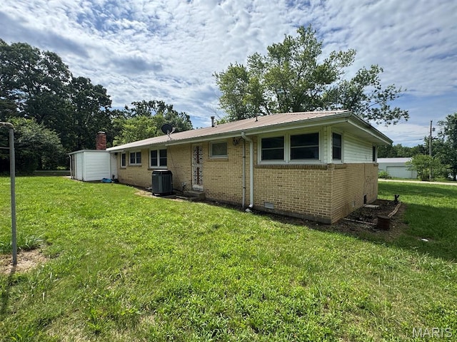 48 E N Ave, Ellsinore, MO 63937 - rear view of property with brick siding, a yard, and a metal roof