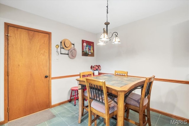 8822 Crest Oak Ln, Saint Louis, MO 63126 - dining room with baseboards and a chandelier