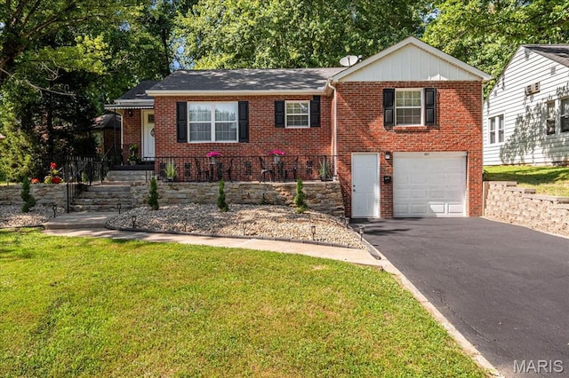 407 N 28th St, Belleville, IL 62226 - view of front of house featuring brick siding, asphalt driveway, a front lawn, and an attached garage
