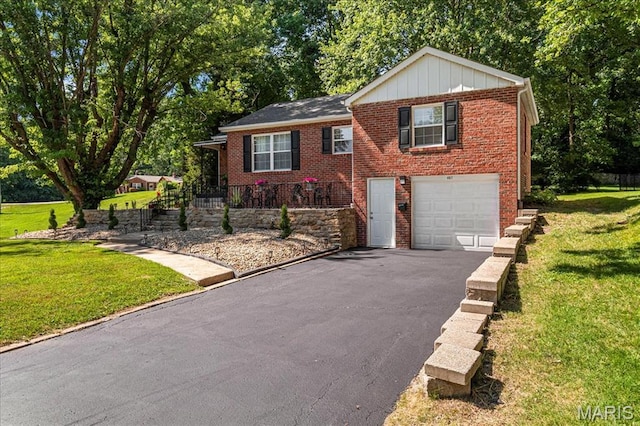 407 N 28th St, Belleville, IL 62226 - view of front of home featuring driveway, an attached garage, a front lawn, and brick siding