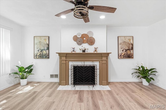407 N 28th St, Belleville, IL 62226 - living room with wood finished floors, a ceiling fan, a fireplace with flush hearth, and recessed lighting