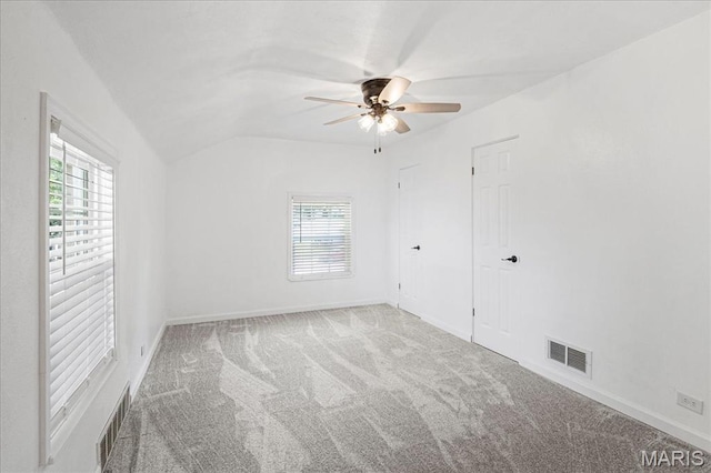 407 N 28th St, Belleville, IL 62226 - unfurnished bedroom featuring multiple windows, carpet, lofted ceiling, and ceiling fan