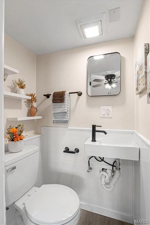 407 N 28th St, Belleville, IL 62226 - bathroom featuring toilet and wood finished floors