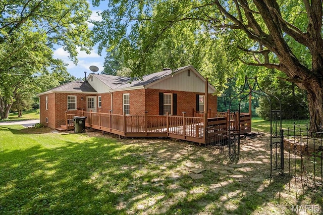 407 N 28th St, Belleville, IL 62226 - back of property featuring brick siding, a lawn, and a wooden deck