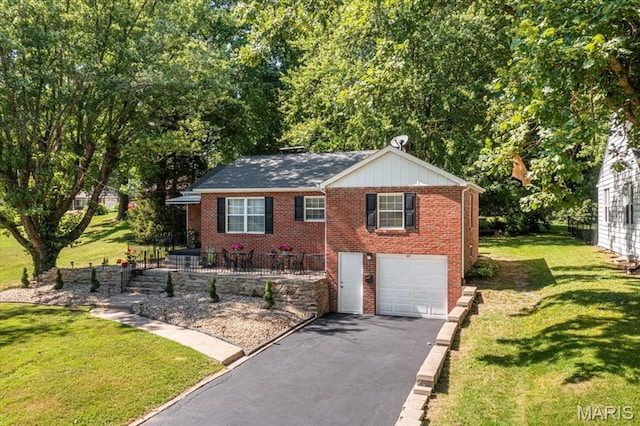 407 N 28th St, Belleville, IL 62226 - view of front of house with driveway, an attached garage, brick siding, and a front lawn