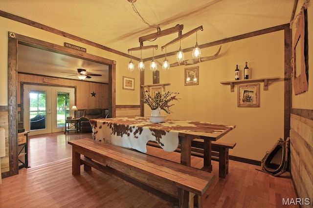 31337 Hudson Rd, Lebanon, MO 65536 - dining room with wood finished floors, french doors, wooden walls, and ceiling fan