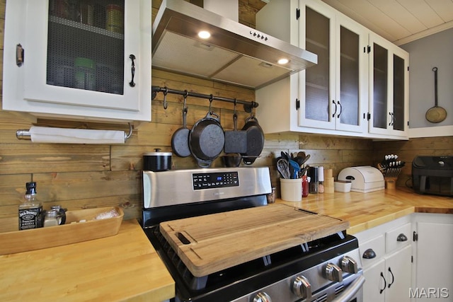 31337 Hudson Rd, Lebanon, MO 65536 - kitchen with stainless steel range, exhaust hood, butcher block countertops, white cabinets, and wood walls