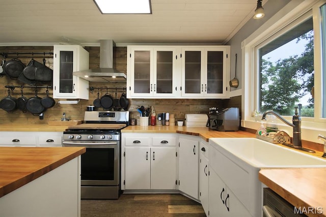 31337 Hudson Rd, Lebanon, MO 65536 - kitchen featuring wall chimney range hood, gas range, butcher block counters, and plenty of natural light