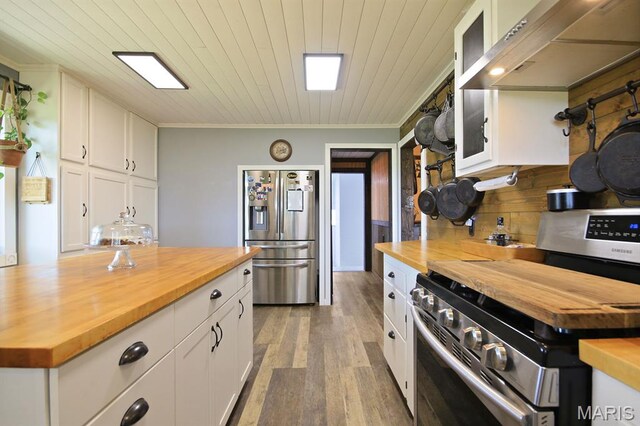 31337 Hudson Rd, Lebanon, MO 65536 - kitchen with wood counters, appliances with stainless steel finishes, range hood, white cabinets, and light wood-style floors