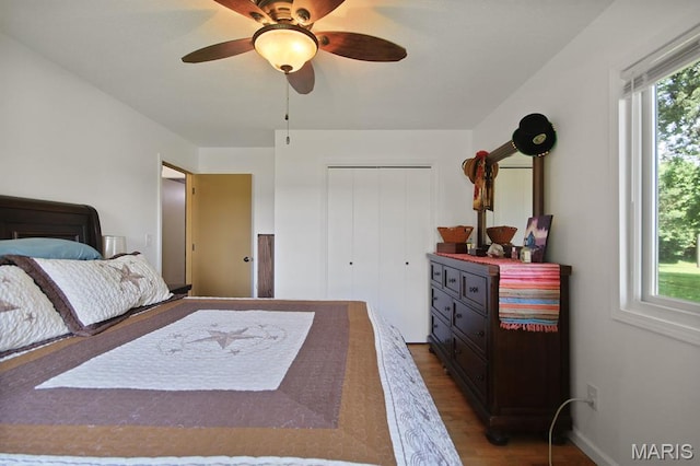 31337 Hudson Rd, Lebanon, MO 65536 - bedroom with dark wood-style floors, a closet, and a ceiling fan