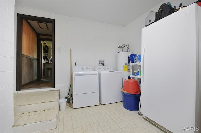 31337 Hudson Rd, Lebanon, MO 65536 - laundry area featuring water heater and washing machine and dryer