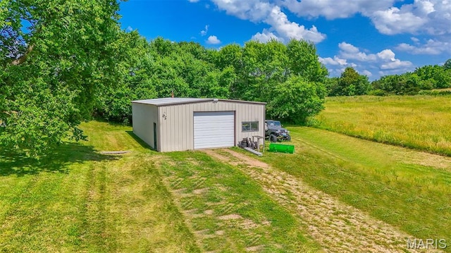 31337 Hudson Rd, Lebanon, MO 65536 - view of green lawn featuring dirt driveway, an outdoor structure, and a garage