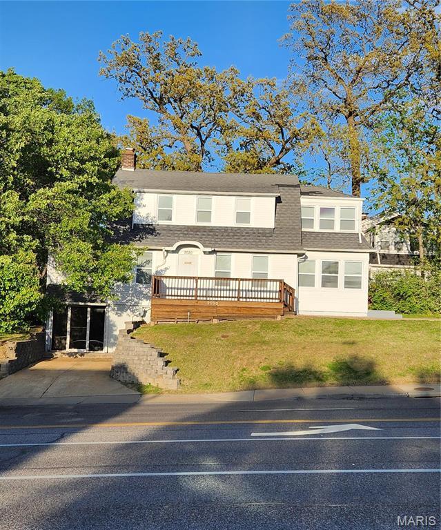 2020 S Brentwood Blvd, Saint Louis, MO 63144 - view of front of house featuring roof with shingles, a chimney, and a front lawn