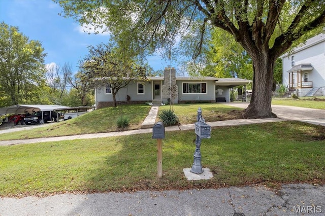 208 E Main St, Iberia, MO 65486 - single story home featuring a chimney, a front lawn, concrete driveway, and a carport